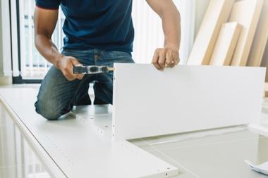 Furniture installations. Man assembling furniture.